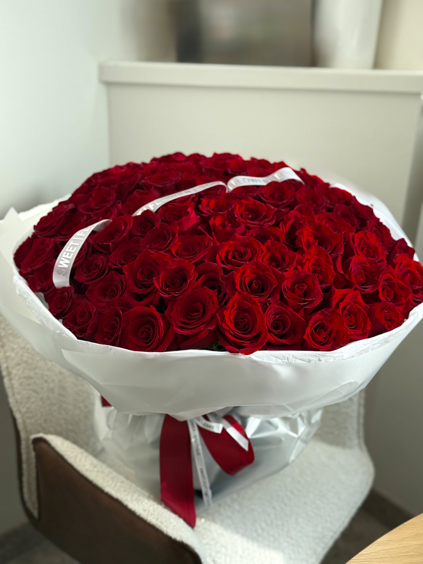 100 red roses bouquet with white wrapping, luxury flower delivery Toronto