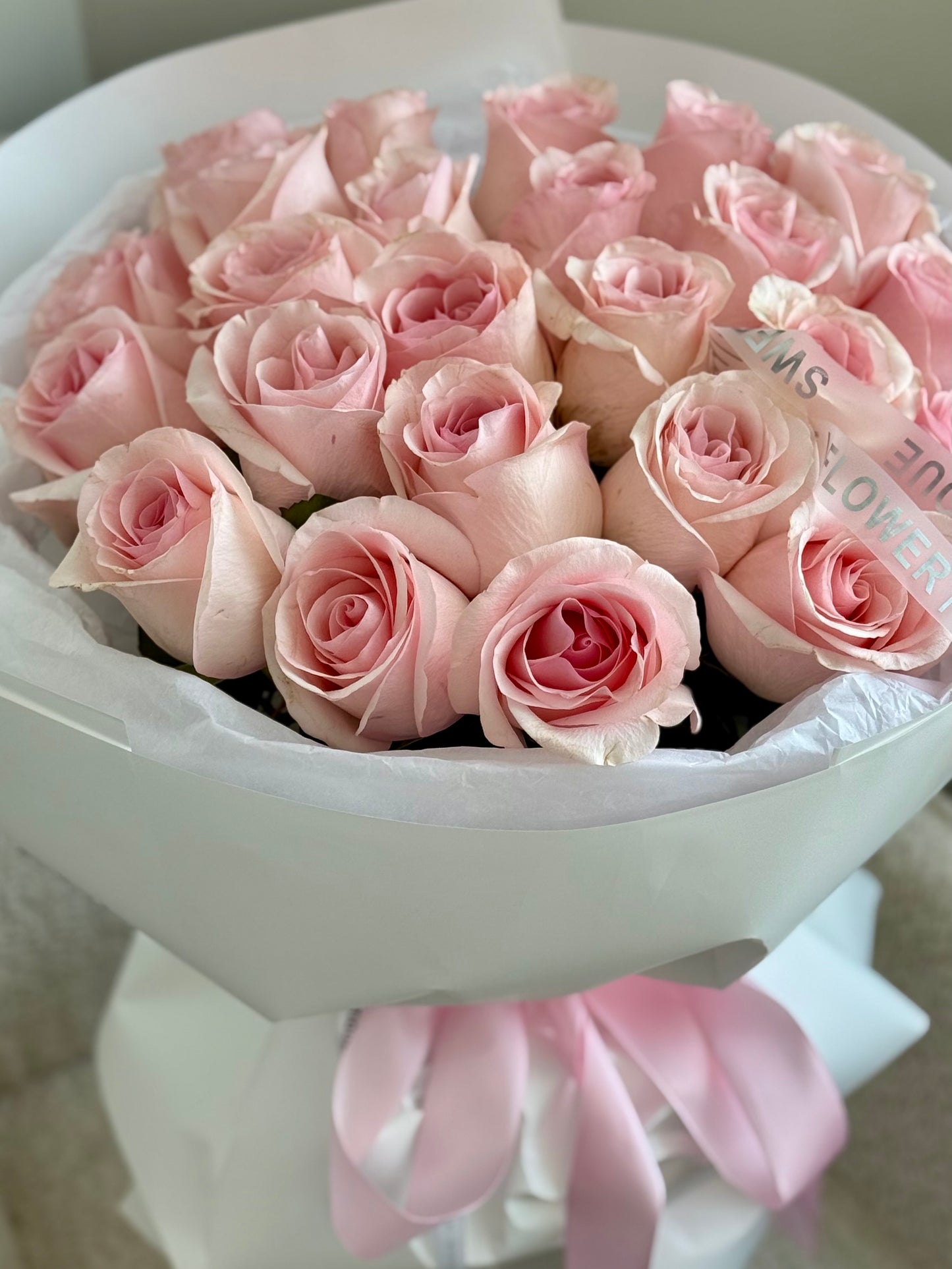 Elegant bouquet of twenty four pink roses with soft blush tones