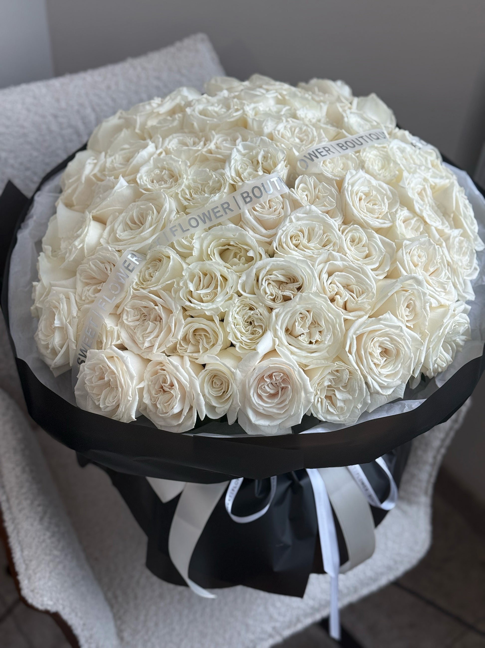 50 white roses luxury bouquet wrapped in black paper by Sweet Flower Boutique