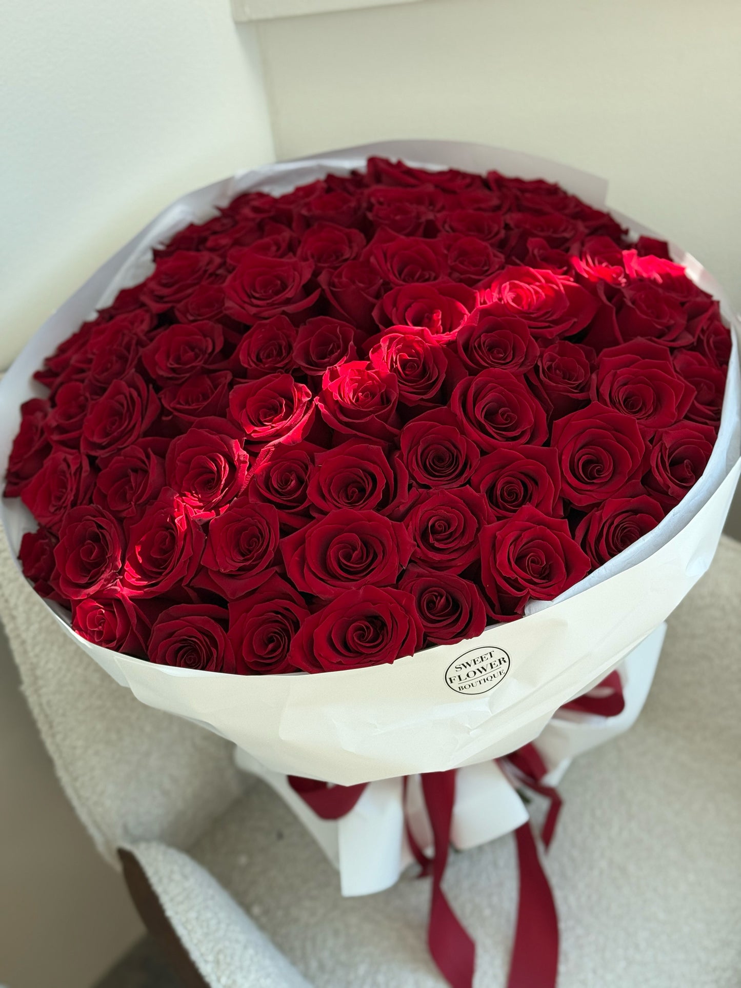 Luxury bouquet of 75 red roses in elegant wrapping, romantic flower gift
