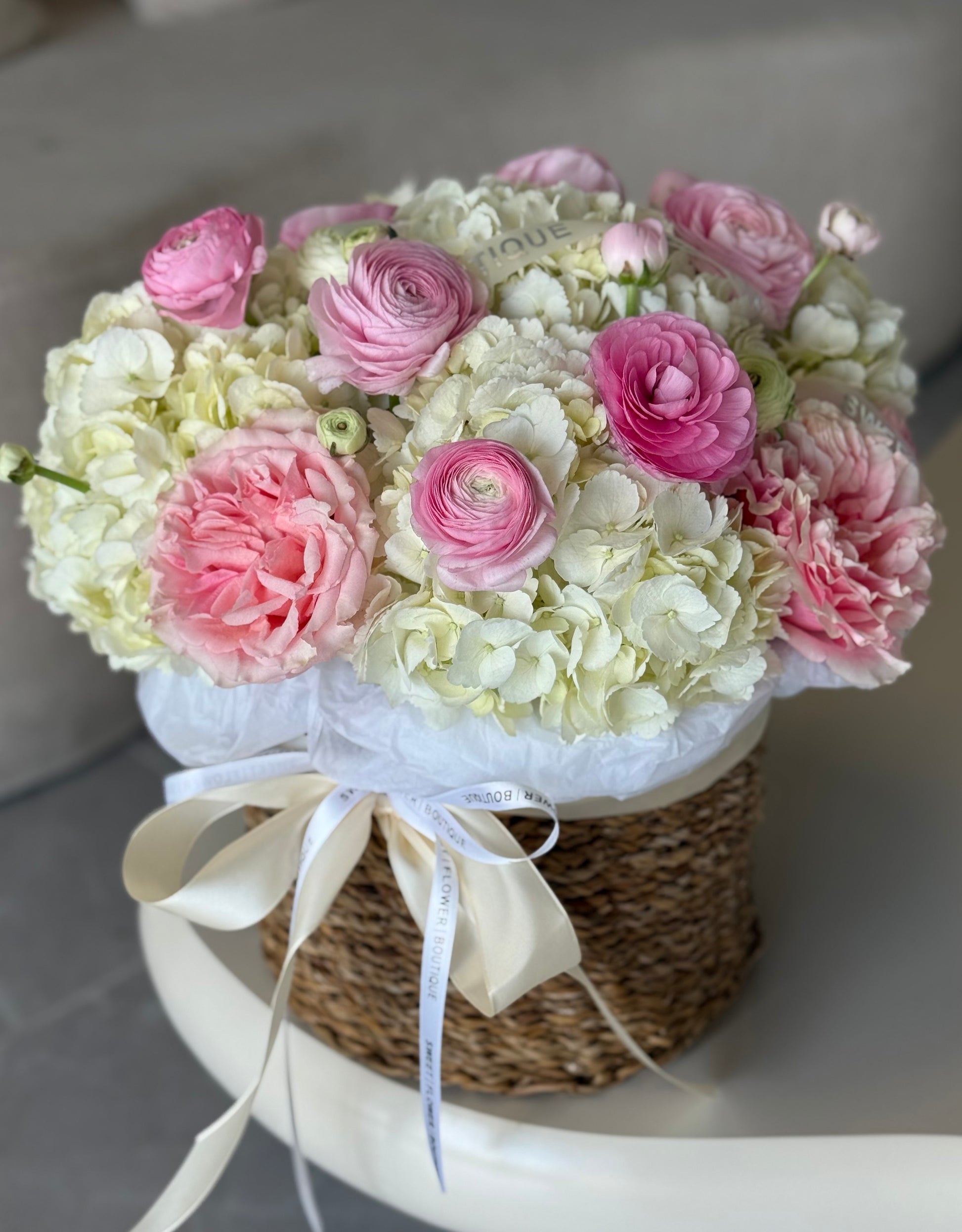 romantic pink ranunculus with white hydrangeas luxury basket arrangement Sweet Flower Boutique