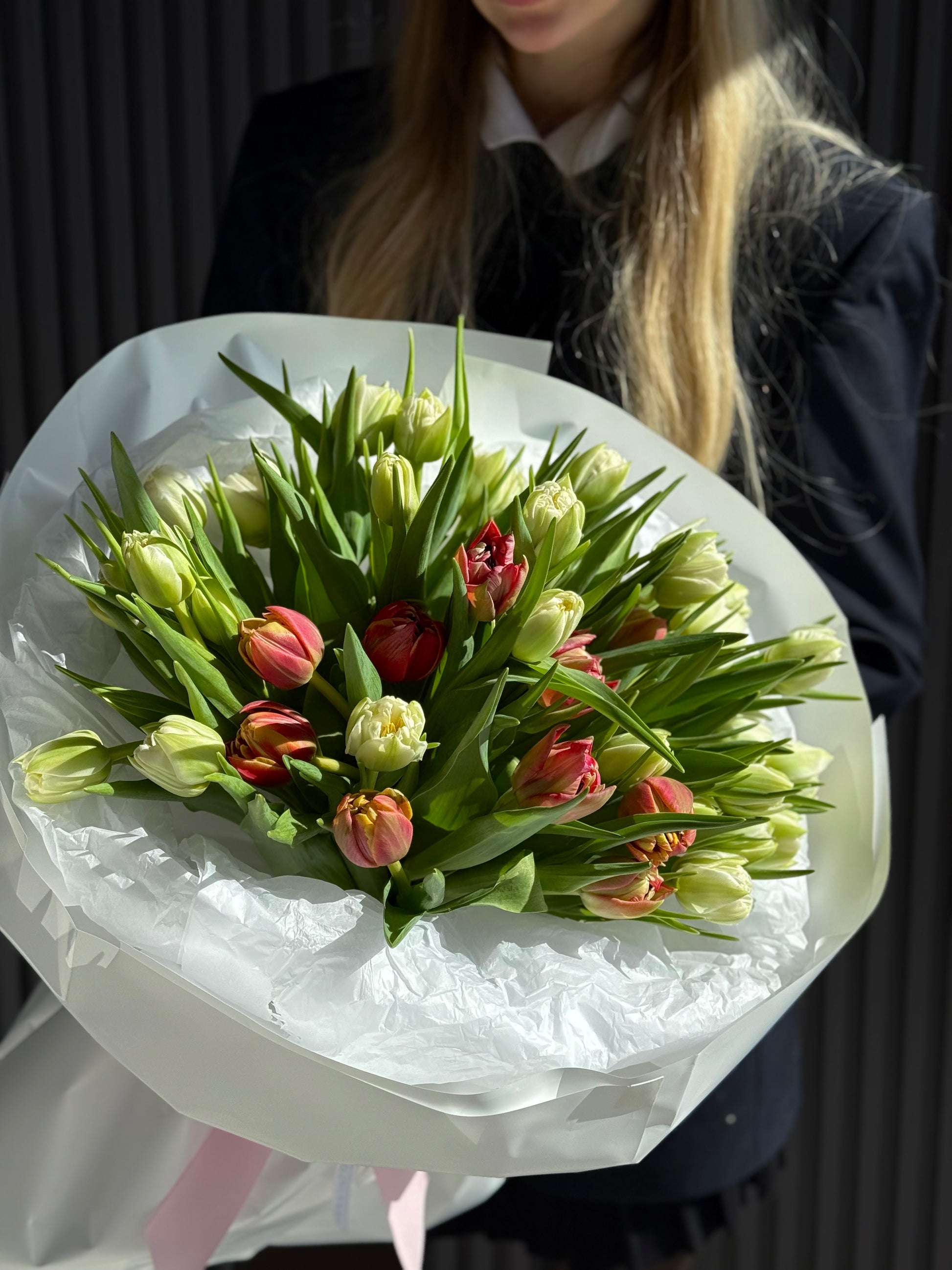 White and pink local double tulip bouquet with layered peony-style petals wrapped in luxury paper, available for same-day delivery in Toronto.