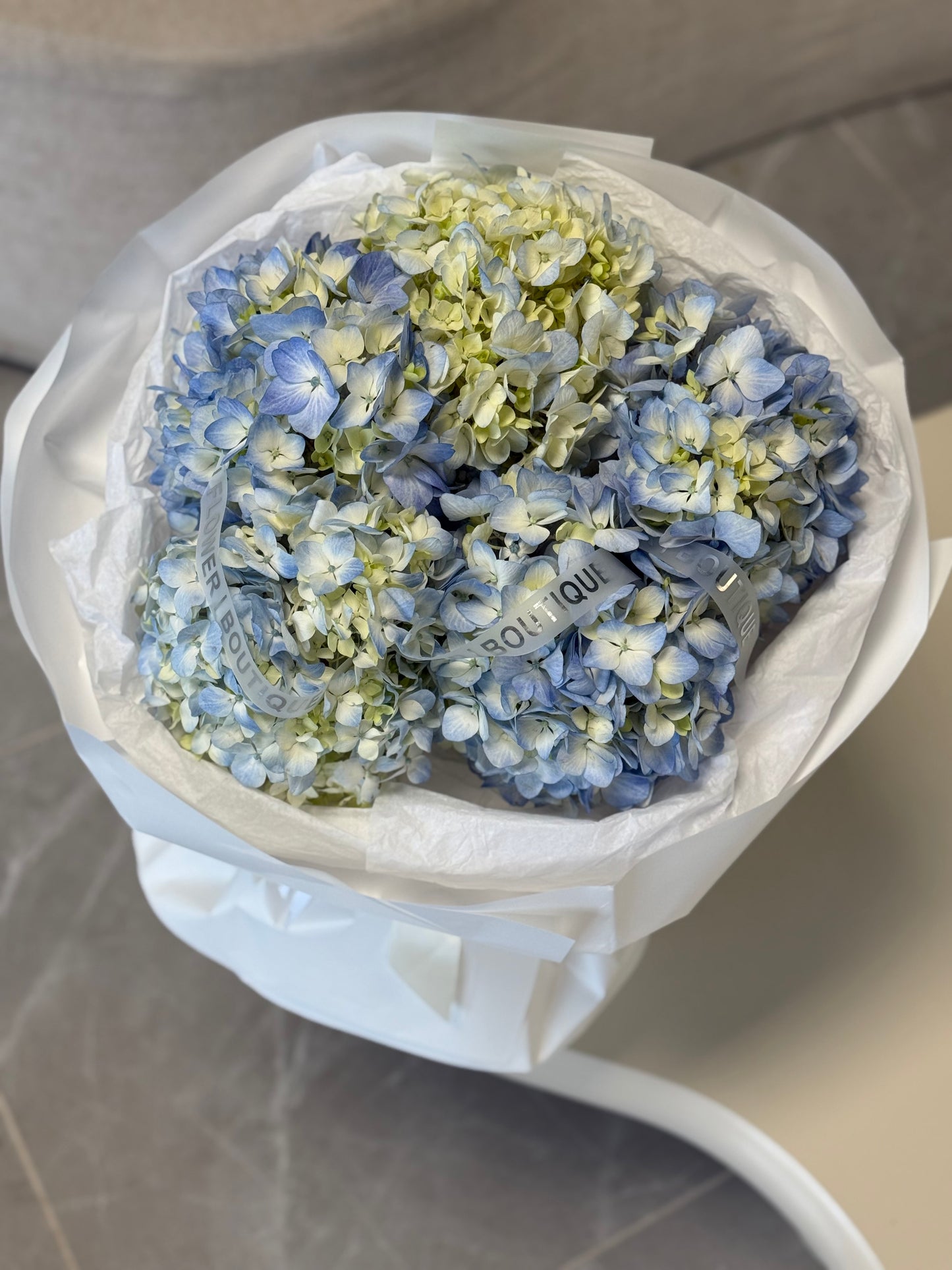 Large hydrangea bouquet with luxury white wrapping and ribbon
