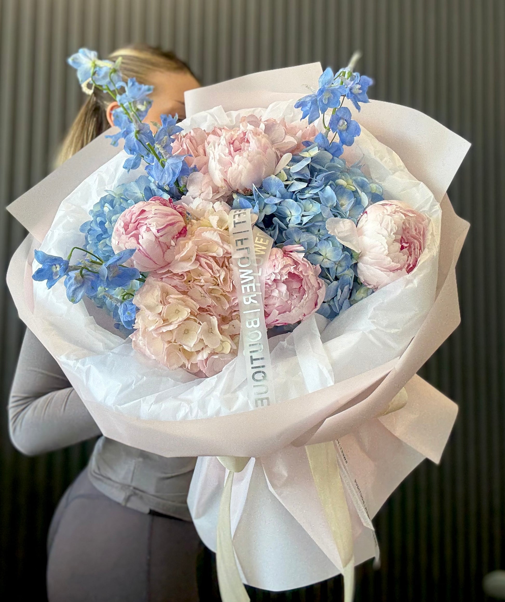 Romantic blue hydrangea bouquet with blush pink peonies