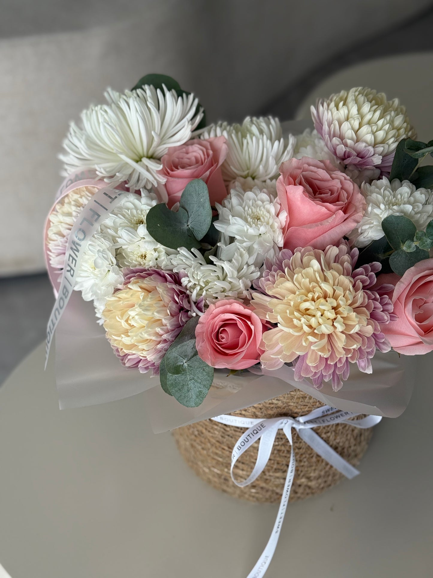 Bouquet of flowers with pink and white roses on a light background