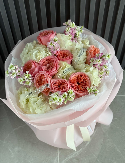 Bouquet of pink and white flowers with visible text on a light background