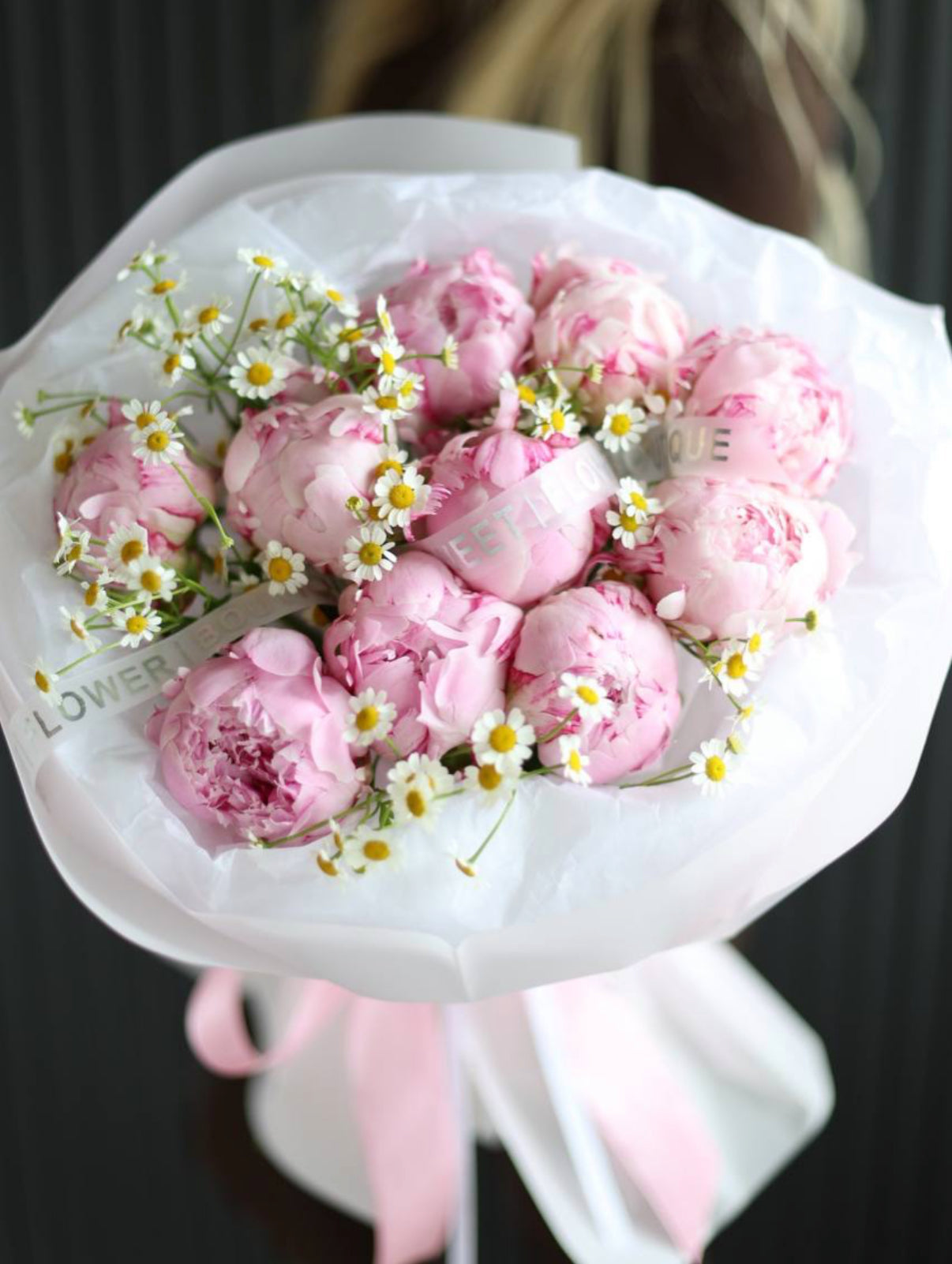 Bouquet of 10 pink peonies with white chamomile flowers in luxury white wrapping