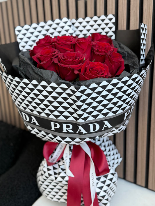12 red roses bouquet in Prada-inspired black and white luxury wrap with red ribbon