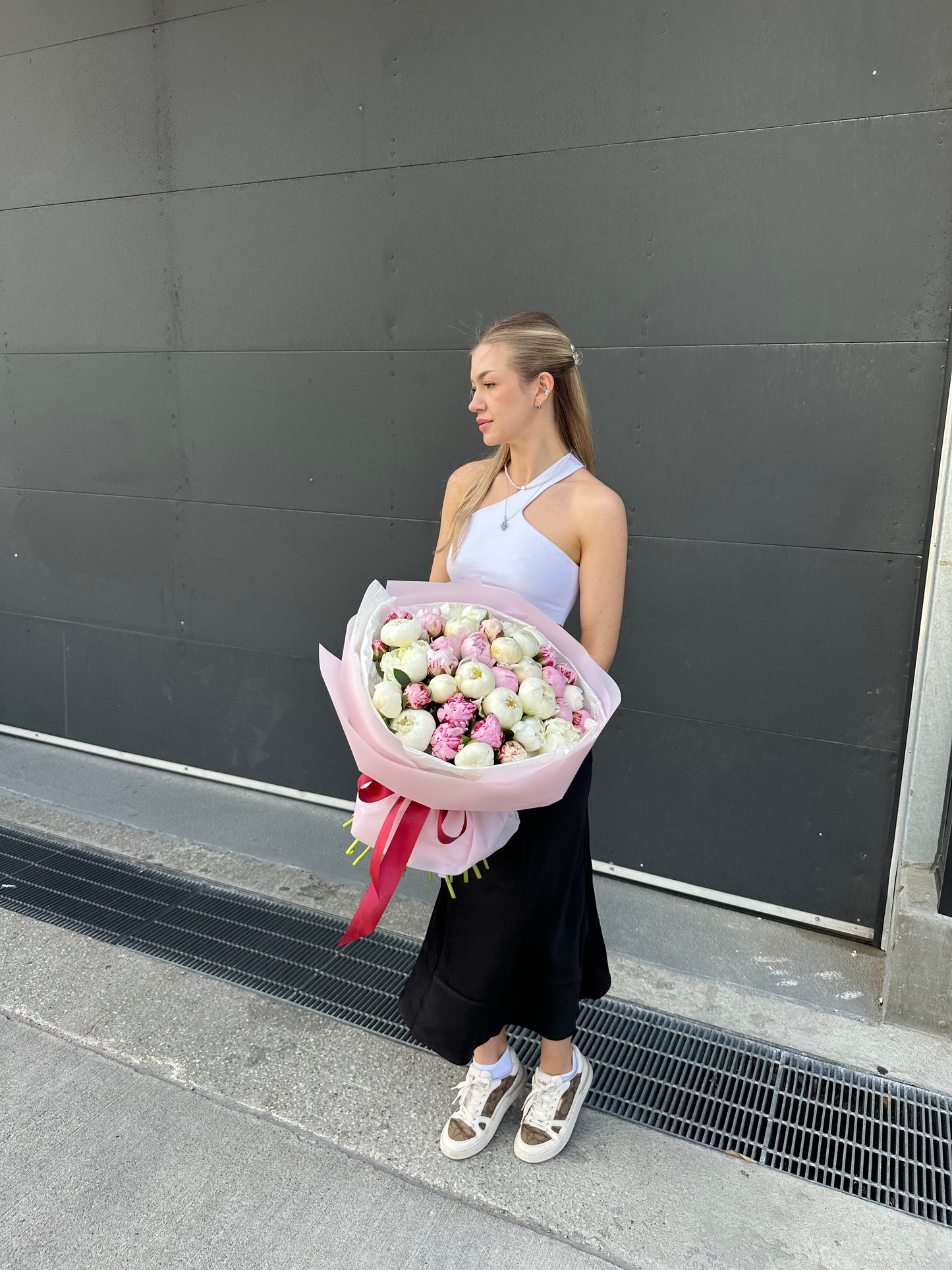 Women holding luxury pink and white peonies bouquet for delivery in Toronto 