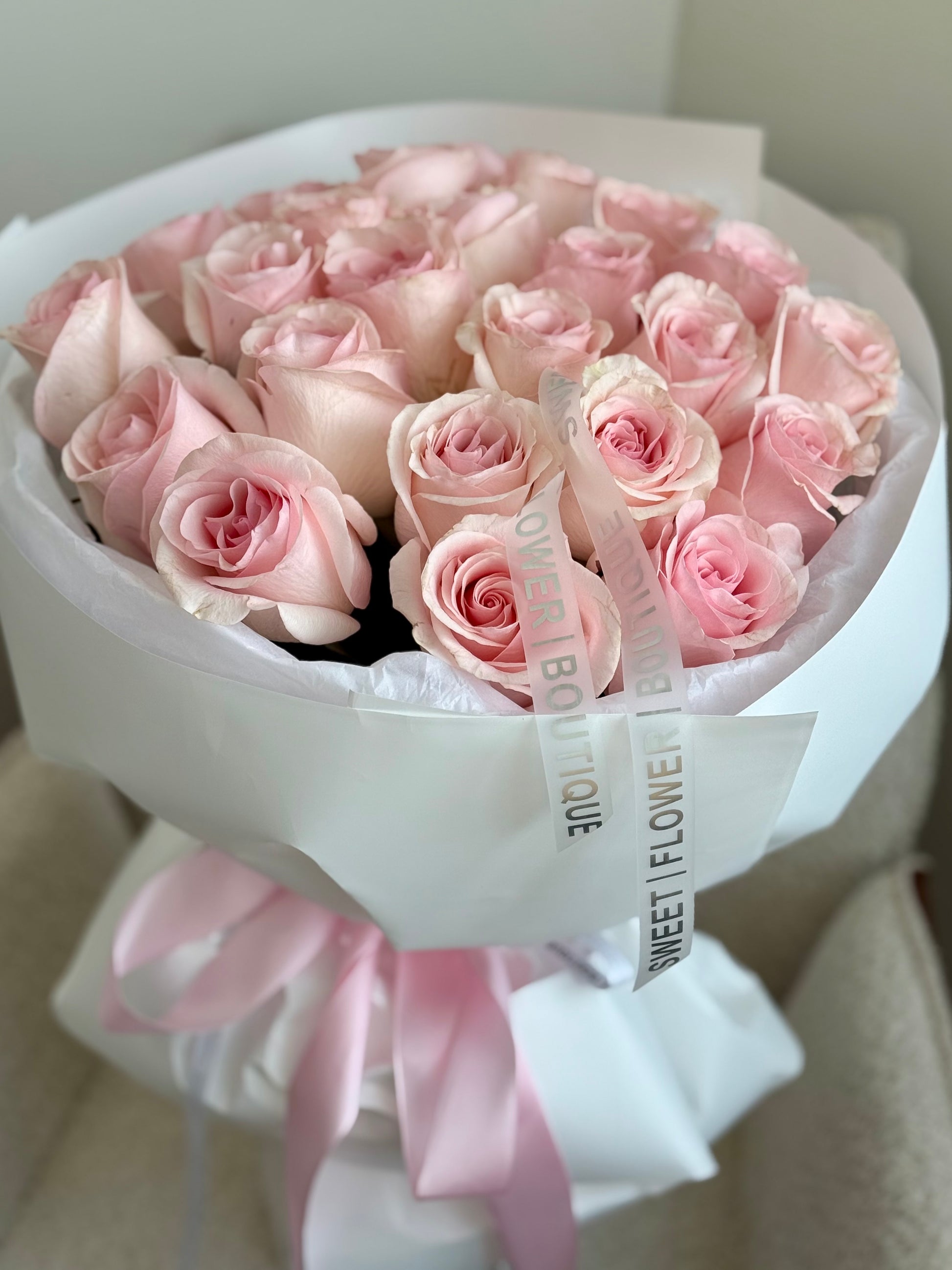 Romantic 24 pink roses arrangement with pastel ribbon detail