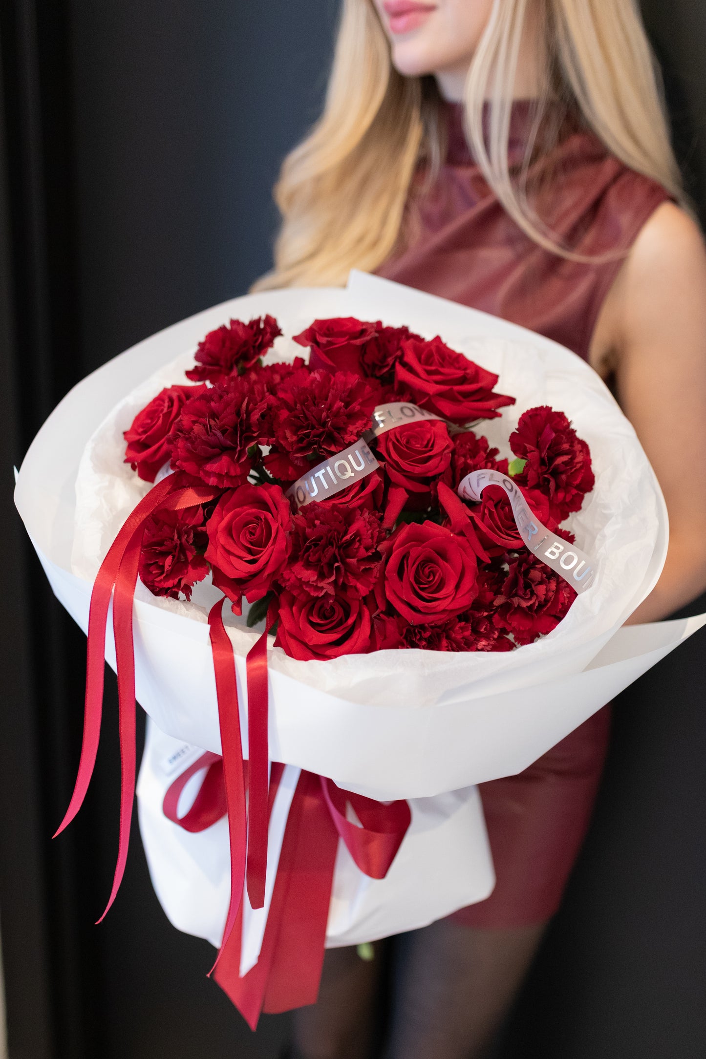 
Red roses and carnations bouquet wrapped in white paper, romantic flower delivery Toronto