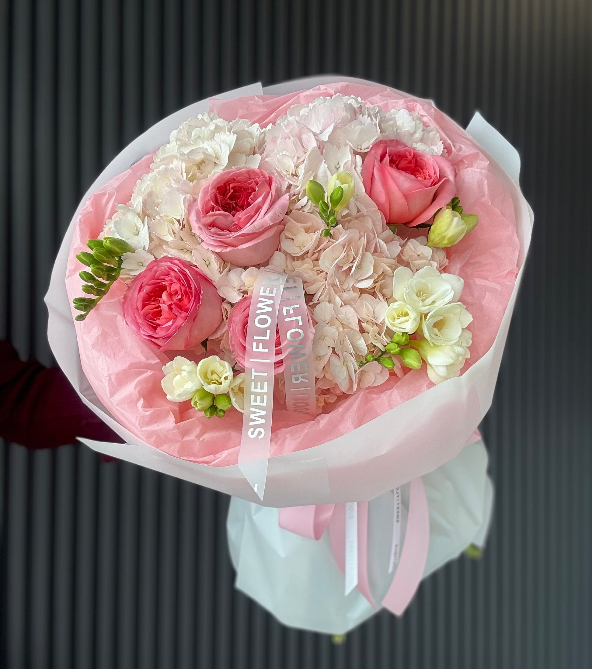 pink garden rose hydrangea bouquet wrapped in soft pastel paper elegant florist GTA