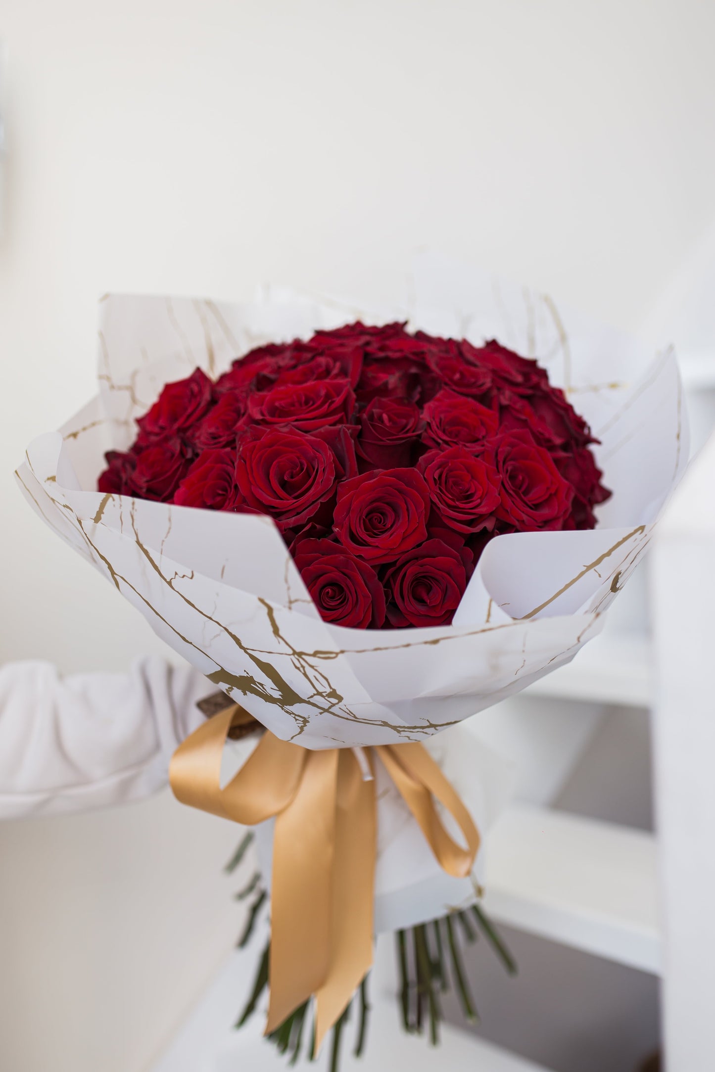 Close-up of premium red roses arranged in a full luxury bouquet