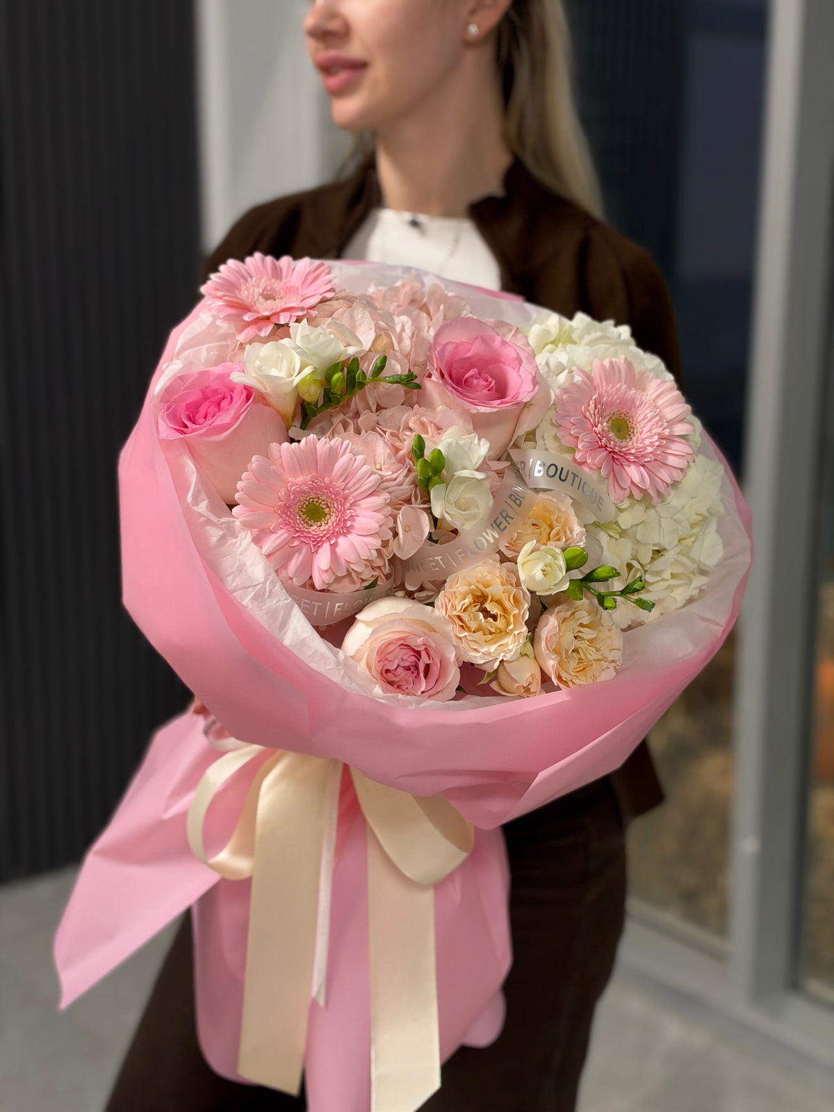 
Luxury Pink Blush bouquet featuring pink roses, champagne garden roses, white hydrangeas and pink gerbera flowers with elegant pink wrapping and satin ribbon.